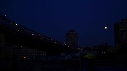 LA WS Full moon near office building and bridge at night / New York City, New York, USA Stock Footage