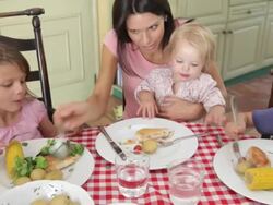 Family Eating Meal Together In Kitchen Stock Footage