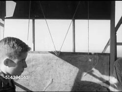 1952: LANEBURG HIGH SCHOOL FOREST: VS State forester Dick Shelton in fire tower talking to Laneburg H.S. student about fire spotting, fire finder instrument, & map (SOT), student spotting area on map. AR Instructional Video