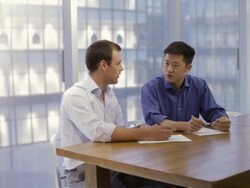 MS Businessmen discussing project in modern office / China Stock Footage