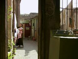 MS Shot of family life in small apartment, women removing dried clothes from hanger / Cairo, Egypt Stock Footage