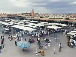 MS  POV T/L Tourist doing shopping and some people opening shop tents  in Djemaa el-Fna square / Marrakech, Morocco Stock Footage