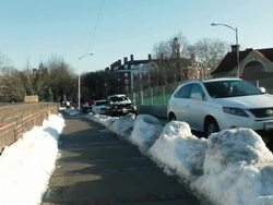 MS Shot of traffic moving on snow covered sidewalk of street in city / Boston, Massachusetts, United States Stock Footage