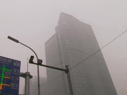 Commuters walking to work in centre of Beijing wearing smog masks. News Clip
