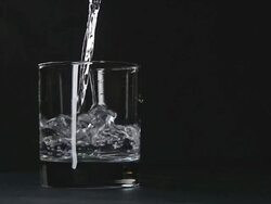 Pure, still water pouring in glass Stock Footage