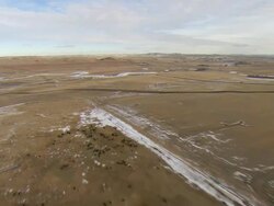 WS AERIAL Shot of cattle ranch and frozen river in Bakken oil field near Watford City / Watford City, North Dakota, United States Stock Footage