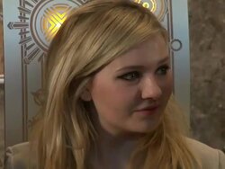 Abigail Breslin poses for photographers in the lobby of the Empire State Building for Project Sunshine Stock Footage
