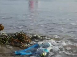 CU Trash on Beach and waves approaching  / Venice Beach, Los Angeles, California, United States Stock Footage