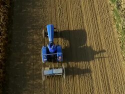 AERIAL Farmer Harrowing A Field Stock Footage