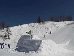 Snowboarder performs a trick in a snowpark Stock Footage