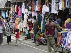 MS  Moslem women passing  souvenir shop near Pura Ulun Danu temple at Lake Bratan / Bedugul, Bali, Indonesia   Stock Footage