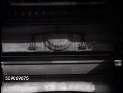 1942: OCCUPIED FRANCE: WS Ministre de la Justice (Minister of Justice) building in Paris. WS Scales of Justice carving on building. VS INT Court of the Provisional (Occupied) Government w/ unidentified men in robes, before bench, HA Sitting at table. Instructional Video