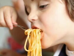 Family Child Eating Spaghetti in Kitchen Stock Footage