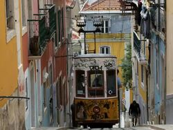 View of tram moving on narrow gauge rails within the city, Lisbon, Portugal, Europe Stock Footage