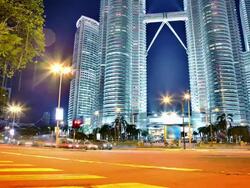 Traffic near Petronas towers in Kuala Lumpur Stock Footage