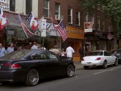 MS PAN View of bar with many flags and large group of African American males on street lined / Philadelphia, Pennsylvania, United States Stock Footage