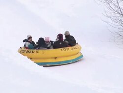 MS TS Snow tubing down the slopes at the Quebec Winter Carnivalr AUDIO / Quebec City, Quebec, Canada Stock Footage