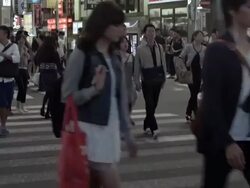 Pedestrians crossing street at crosswalk in Shinjuku, Tokyo, Japan. Stock Footage