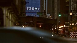 A sign spelling TRUMP looms over Wabash Avenue at night in Chicago. Stock Footage