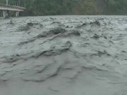 Muddy River Flood Waters Flow Under Bridge Stock Footage