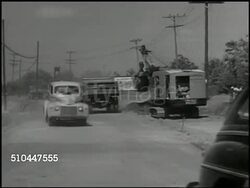 1949: U.S. HIGHWAY CONSTRUCTION: WS Traffic passing by road construction, truck, backhoe scoop loader machine. WS Traffic behind slow moving truck. CU Sign 'Trucks Use Right Lane.' WS Cars passing slow truck on rural highway. Instructional Video