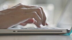 Close-up of a man typing on a laptop keyboard Stock Footage