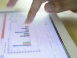 Tablet touch screen and business financial graph Stock Footage