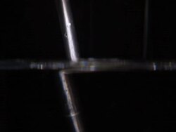 CU, metal rod is dipped into water to display light distortion in water., with audio, sound available Stock Footage