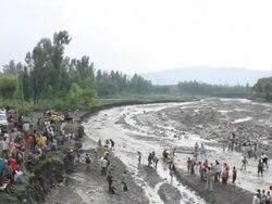 River bank and people trying to cross river Stock Footage