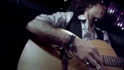 Rockstar jams in limousine while fans beat on glass and cameras flash at awards show Stock Footage