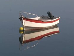 MS Boat bobbing on water and reflection seeing in water / Saint-Cado, Brittany, France Stock Footage