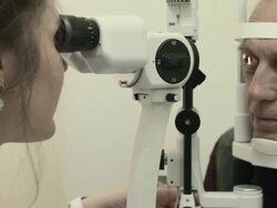 Optometrist examines man's eyesight Stock Footage