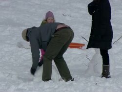  MS ZO ZI Family building snowman in Central Park / New York, New York, United States Stock Footage