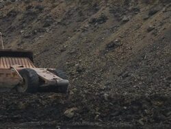 Caterpillar construction vehicles excavate a building site Stock Footage