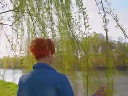 TS Young woman walking under the tree Stock Footage