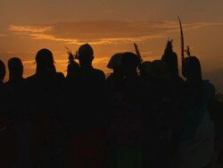 Maasai Ceremony - Young warriors dancing, singing silhouetted at sunset, WITH AUDIO Stock Footage
