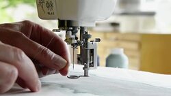 Woman threading needle Stock Footage