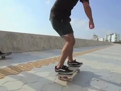 MS POV Two men's skateboarding on side walk beach area / Chatan, Okinawa, Japan Stock Footage