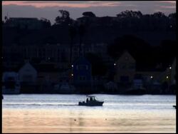 Motor Boat Passes Glistening Sunrise /Sunset Water Stock Footage