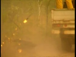 MS Fire fighter setting fire to grass in back burn Stock Footage