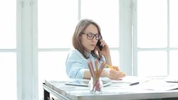 Young female entrepreneur talking on the phone in her office. Stock Footage