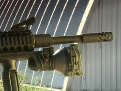 Medium Close Up pan-left pan-right - A Beowulf rifle stands on a platform in front of a quonset hut.  Stock Footage