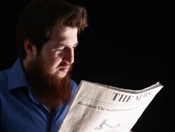 Man sneezing while reading newspaper Stock Footage