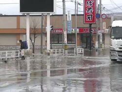 Destruction caused by tsunami after magnitude 9 Tohoku earthquake, north east Japan, March 2011. Trucks drive through tidal flooding in Ishinomaki, Miyagi Prefecture after tsunami Stock Footage