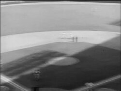 B/W 1955 high angle PAN players throwing ball + runner returning to first base / World Series / NYC Stock Footage