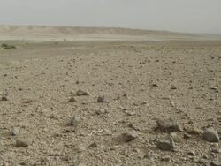 Static shot of a barren landscape, with mountains in the background. Stock Footage