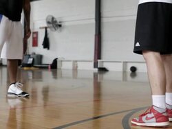 MS  Two young men playing basketball against each-other inside  gymnasium / Minneapolis, Minnesota, United States  Stock Footage