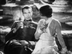 B/W 1932 man in WW I uniform (Gary Cooper) + nurse (Helen Hayes) sitting outdoors drinking / feature Stock Footage