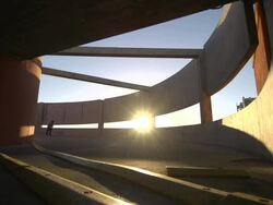 A young man skateboarding down a spiral ramp in a parking garage. - Slow Motion Stock Footage