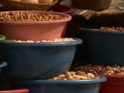 "R-L Pan Nuts, pulses, beans and olives in red and blue stacked bowls on market stall, Chachapoyas market, Chachapoyas, Peru [PerÃƒÂº]" Stock Footage